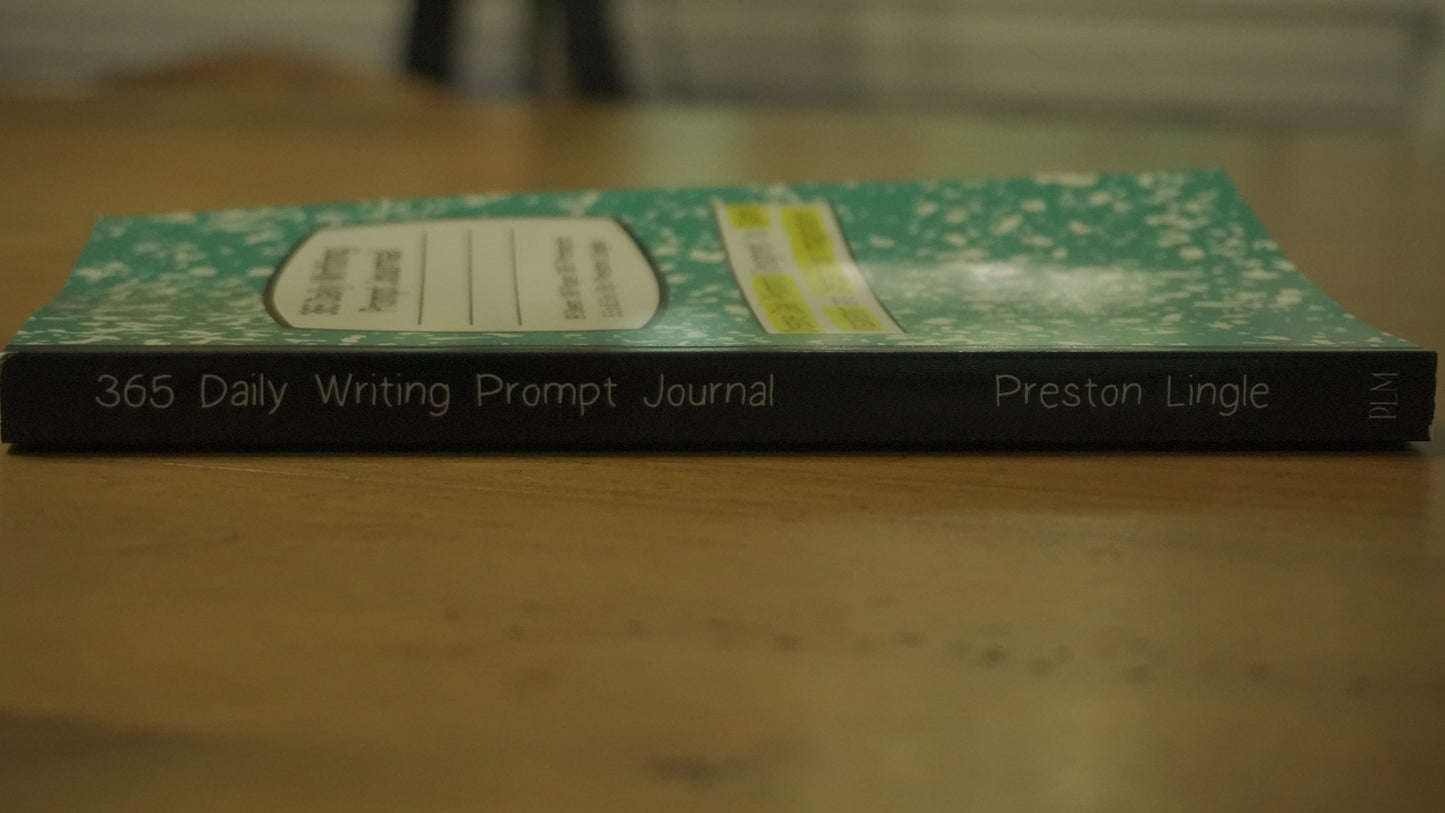 Journal titled '365 Daily Writing Prompt Journal' by Preston Lingle on a wooden surface.