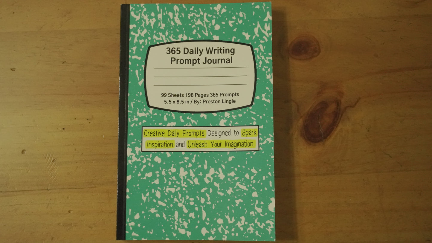 Green and black journal with writing prompts on a wooden surface
